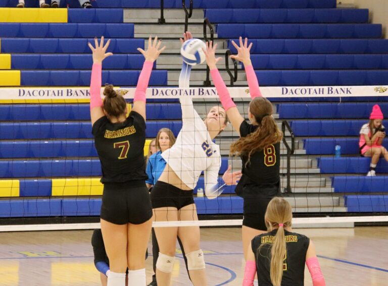 Aberdeen Central's Lauryn Burckhard hits through the block attempt by Harrisburg's Bergan Stiff, left, and Josalyn Samuels Thursday, Oct. 17 in Golden Eagles Arena. Burckhard was named to the Class AA all-state team. Aberdeen Insider photo by Robb Garofalo.