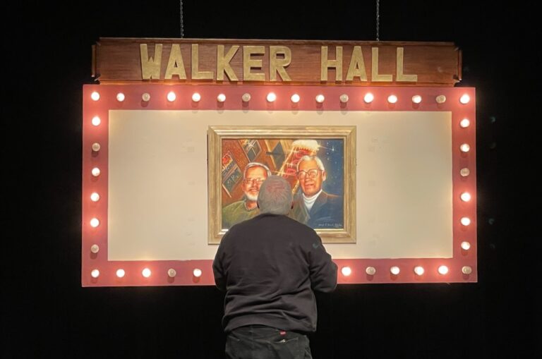 Jim Walker stands in front of a commissioned painting of he and Don Hall, both of whom were pivotal in the creation of the Aberdeen Community Theatre. Aberdeen Insider photo by Troy McQuillen.
