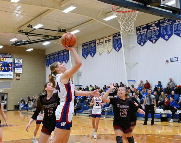 Warner's McKenna Leidholt drives past Aberdeen Christian's Ari Johnson (left) and scores during the second quarter of their game Tuesday, Dec. 17 in Warner. Aberdeen Insider photo by Robb Garofalo.