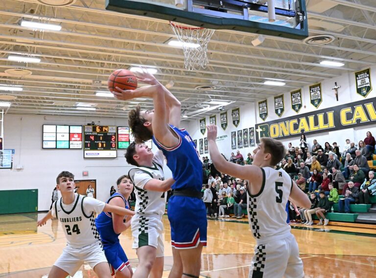Warner's Brennan Wolf-Donat scores on off an offensive rebound during the first quarter Thursday, Dec. 19 at Aberdeen Roncalli. The Monarchs won 47-46. Aberdeen Insider photo by Robb Garofalo.