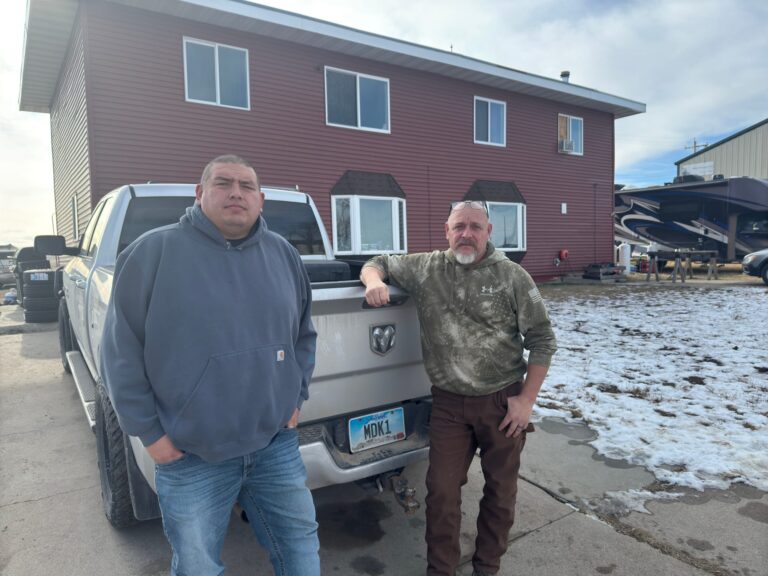 Chris Yellow Thunder, left, with David Streeter on Dec. 7, 2024, outside Yellow Thunder's home in Igloo where both of their families now live. (Photo: Bart Pfankuch / South Dakota News Watch)
