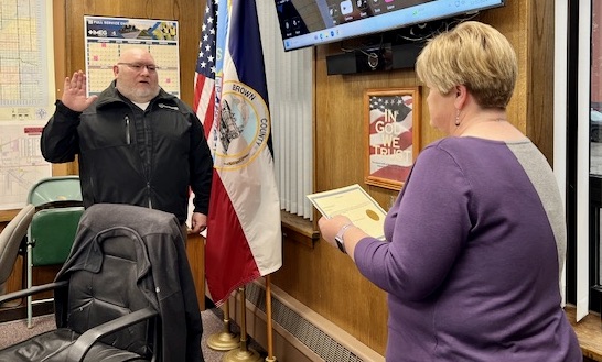 Brown County Auditor Lynn Heupel, right, swears in Brian Koens as Brown County deputy during the Tuesday, Dec. 31 Brown County Commission meeting at the courthouse annex. Photo courtesy of Duane Sutton.