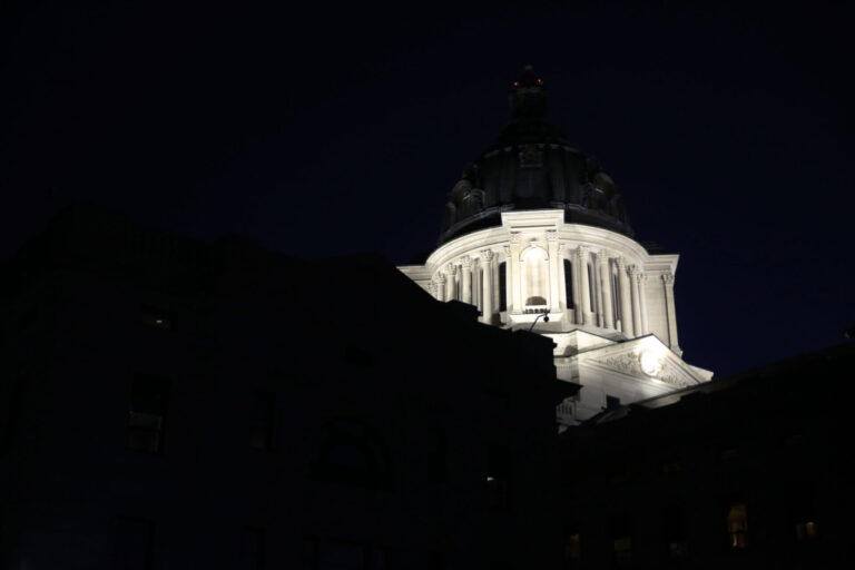 The South Dakota Capitol light at night. South Dakota Searchlight photo.