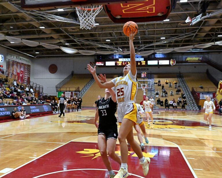 Northern State's Izzy Moore scores in front of Minnesota Duluth's Lexi Karlen Friday, Jan. 3 at Wachs Arena. The Wolves defeated Duluth and Concordia-St. Paul over the weekend. Aberdeen Insider photo by Robb Garofalo.