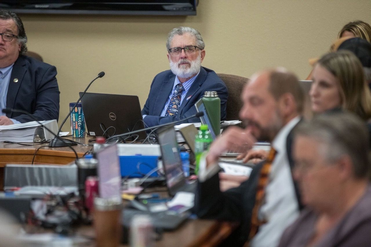 Lynn Helms, center, director of the North Dakota Department of Mineral Resources, listens June 11, 2024, during a public hearing in Bismarck on proposed carbon dioxide storage that would be connected to the Summit Carbon Solutions pipeline. North Dakota Monitor photo by Kyle Martin.