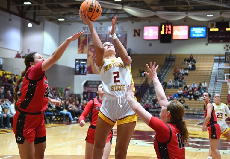 Northern State's Maddie Bragg drives to the rim in between Minnesota State Moorhead's Terryn Johnson, left, and natalie Jens during the fourth quarter Thursday, Jan. 30 inside Wachs Arena. Bragg scored 20 points in a 69-60 win. Aberdeen Insider photo by Robb Garofalo