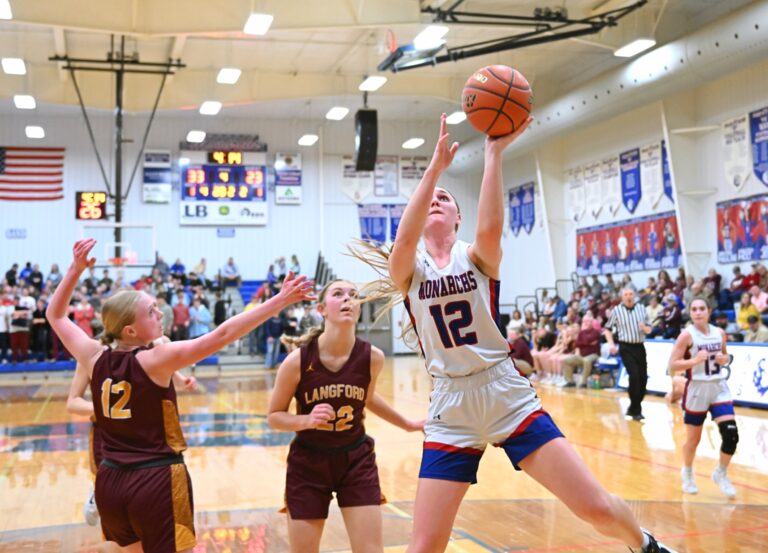 Warner's Stacia Carda drives past Langford's Alex Darling, center, and Lizzie Gustafson during the fourth quarter of their Region 1B quarterfinal Tuesday, Feb. 25 in Warner. Carda had 17 points to lead Warner to a 40-28 win. Aberdeen Insider photo by Robb Garofalo.