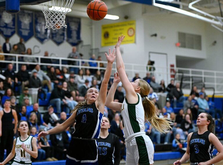Aberdeen Roncalli's McKenna O'Keefe drives on Mount Vernon/Plankinton's Alyssa Johnson in the first quarter of their SoDak 16 game Thursday, March 6 in Redfield. Roncalli's season ended with a with a 58-51 loss. Aberdeen Insider photo by Robb Garofalo.