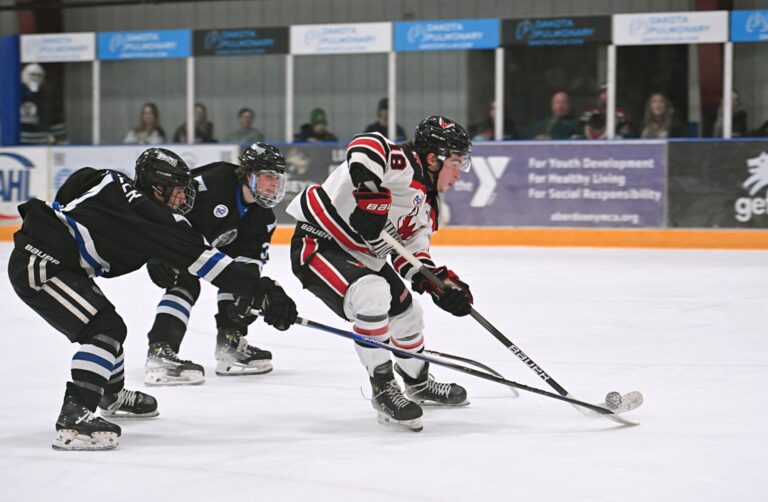 Aberdeen forward Jack McDonough skates past St. Cloud's Kevin Miller, left, and Tim Runtso for a shot on goal during the first period Saturday, March 8 at the Odde Ice Center. McDonough would score the first goal of the game in a 4-2 Wings win. Aberdeen Insider photo by Robb Garofalo.