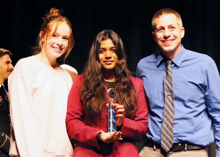 Central's Amna George, center,took first place in Informative Speaking at the state high school debate tournament in Brookings March 7 and 8. Standing with her are, left, assistant coach Alli Joeger and, right, debate coach Kerry Konda. Photo courtesy of South Dakota Public Broadcasting.