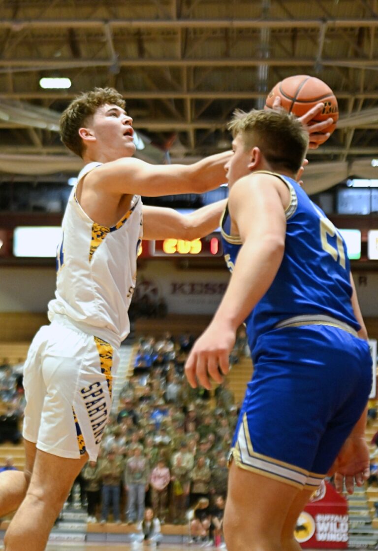 Ryder Michalek of Wessington Springs drives around Wall's Trevor Schultz during their Class B quarterfinal game Thursday, March 20 at Wachs Arena. Michalek had 19 points and 11 rebounds to help the Spartans to a 74-52 win. Aberdeen Insider photo by Allie Hoekman.
