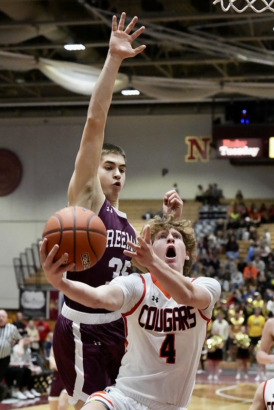 Nolan Kolthoff of Viborg-Hurley drives to the hoop against Freeman's David Walter during the Cougars' 72-44 victory Thursday, March 20 in the quarterfinals of the Class B boys state basketball tournament at Wachs Arena. Photo courtesy of South Dakota Public Broadcasting.