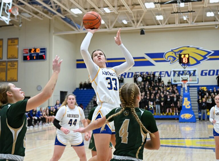 Aberdeen Central's Lauryn Burckhard takes a pull-up jumper in the lane over Sioux Falls Jefferson's Peyton Krull (4) and Abby Horner during their SoDak 16 game Friday, March 7 at Golden Eagles Arena. Burckhard was named to the Class AA second team all-state girls basketball team. Aberdeen Insider photo by Robb Garofalo.