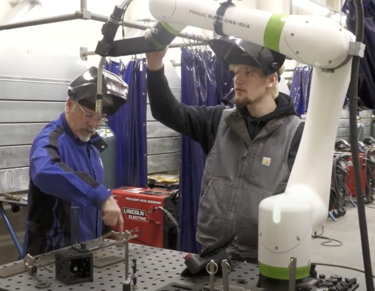 Cole Dunlavy, a sophomore at Central High School, and ATEC Academy welding instructor Mike Lillis use a robotic welder during a demonstration. Courtesy photo.