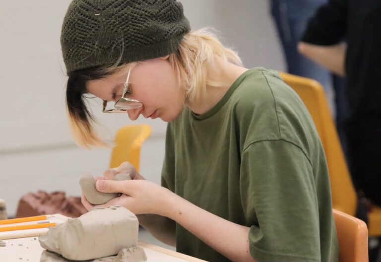 Aberdeen Central's Raini LaBrosse works on her ceramics piece, which placed third at the state Art Wars contest on Saturday, April 12 at the Aberdeen Cultural & Recreation Center.  LaBrosse also placed second in digital art. Aberdeen Insider photo by Elisa Sand.
