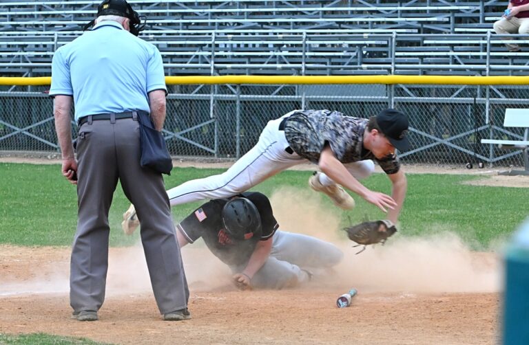 Aberdeen Smittys pitcher Jackson Post leaps over Brookings' Max Jensen after applying the tag at home plate in game two of their doubleheader Monday, April 21 at Fossum Field. Jensen was called out, but Brookings picked up a 13-2 win. Aberdeen Insider photo by Robb Garofalo.