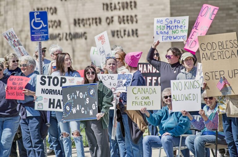 About 125 local residents attended a Hands Off! rally on Saturday, April 19 in front of the Brown County Courthouse. More than 300 pounds of food for The Salvation Army was collected during the event organized by the Brown County Democrats. Photo courtesy of Greg Gilbertson.
