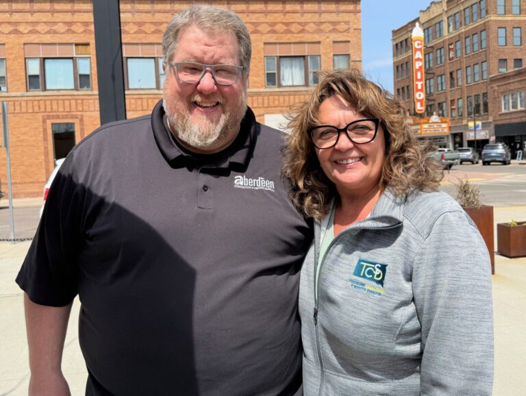 Casey Weismantel, executive director for the Aberdeen Area Convention & Visitors Bureau, stands with Carmen Schramm, executive director of the Tourism Coalition of South Dakota. Aberdeen Insider photo by Elisa Sand.