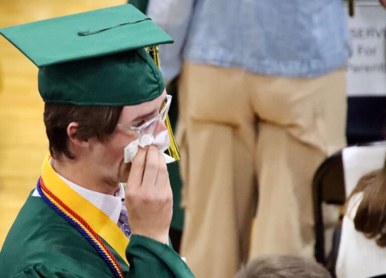 Roncalli High School senior Ben Goebel wipes away a tear as he proceeds into the gym at the beginning of the Roncalli graduation ceremony on Saturday, May 17. Aberdeen Insider photo by Scott Waltman.
