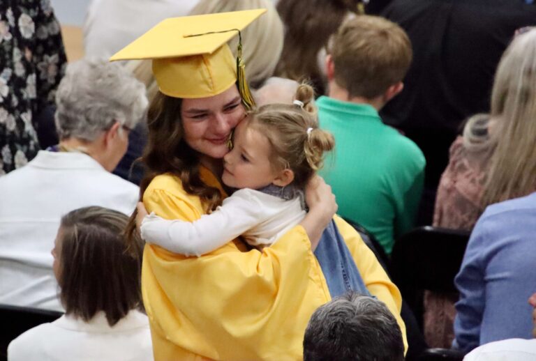 Andrea Woytassek gets a hug during the Roncalli High School graduation ceremony on Saturday, May 17 at the Roncalli Gym. Thirty-five seniors graduated. Aberdeen Insider photo by Scott Waltman.