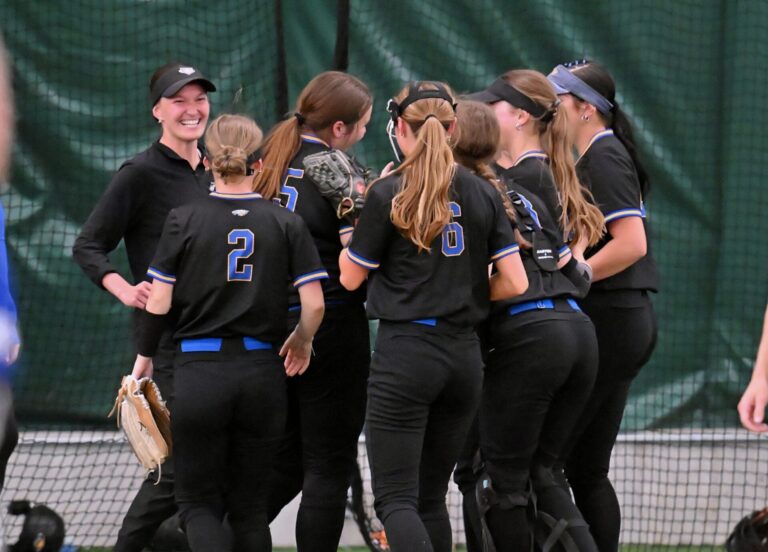 Aberdeen Central head coach Cassidy Neer and her team celebrate following their 5-4 win over O'Gorman Monday, May 19 in the Aberdeen Dome. Aberdeen Insider photo by Robb Garofalo.