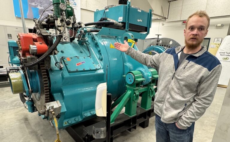 Matthew Pearson, an instructor in the wind technology program at Mitchell Tech in Mitchell, shows a turbine students can work on in a lab at the school on April 8. South Dakota News Watch photo by Bart Pfankuch.