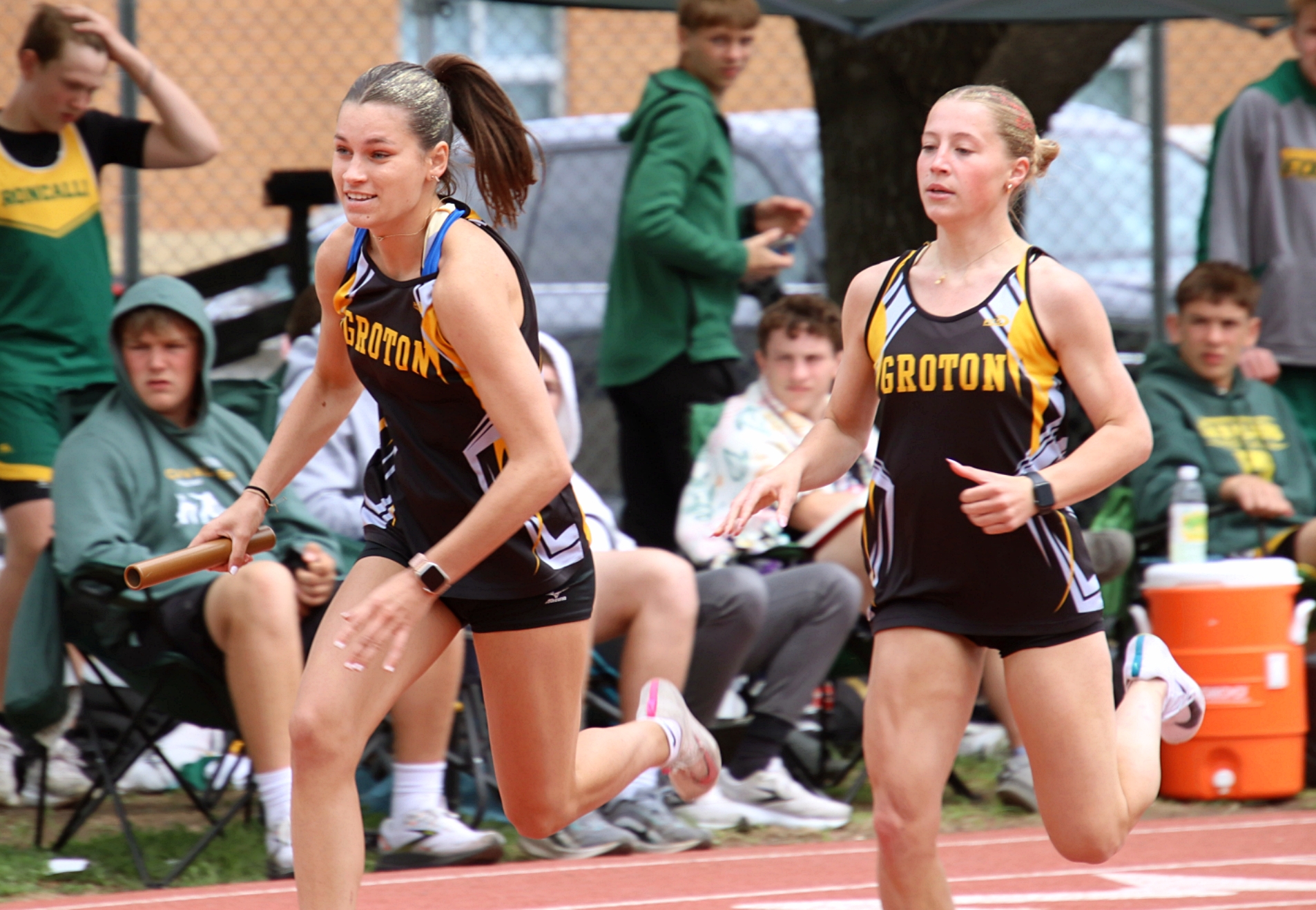 Groton Area's Kella Tracy takes the baton from Laila Roberts for the anchor leg of the 800-meter relay Friday, May 23 at the Warner Dial-A-Move Last Chance Meet. All five Groton girls relay teams have qualified for the state meet this weekend in Sioux Falls. Aberdeen Insider photo by Robb Garofalo.