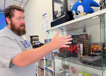 Levi Lather talks about some of the features of the Atari Jaguar, a short-lived game platform he has on display at the Game Shop, which is now open at 8 Second Ave. S.E.. Aberdeen Insider photo by Elisa Sand.
