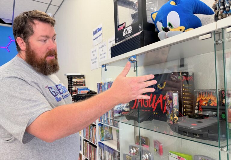 Levi Lather talks about some of the features of the Atari Jaguar, a short-lived game platform he has on display at the Game Shop, which is now open at 8 Second Ave. S.E.. Aberdeen Insider photo by Elisa Sand.