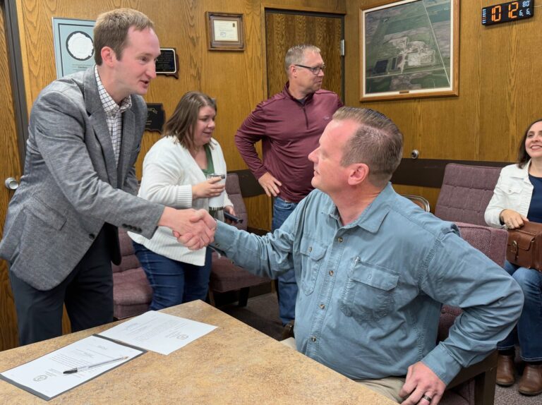 Aberdeen City Finance Officer Jordan McQuillen, left, shakes hands with the newest member of the Aberdeen City Council, Talmage Ekanger, on Friday, June 6 at the Brown County Courthouse. Ekanger was appointed early and given the oath of office following Friday's vote canvass at the Brown County Courthouse. Aberdeen Insider photo by Elisa Sand.