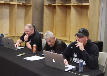 Aberdeen Wings head coach Scott Langer, right, owner Greg Odde and president Aaron Smith track the opening round of the North American Hockey League Draft Wednesday, June 11 inside the Wings locker room at the Odde Ice Center. Aberdeen Insider photo by Robb Garofalo.
