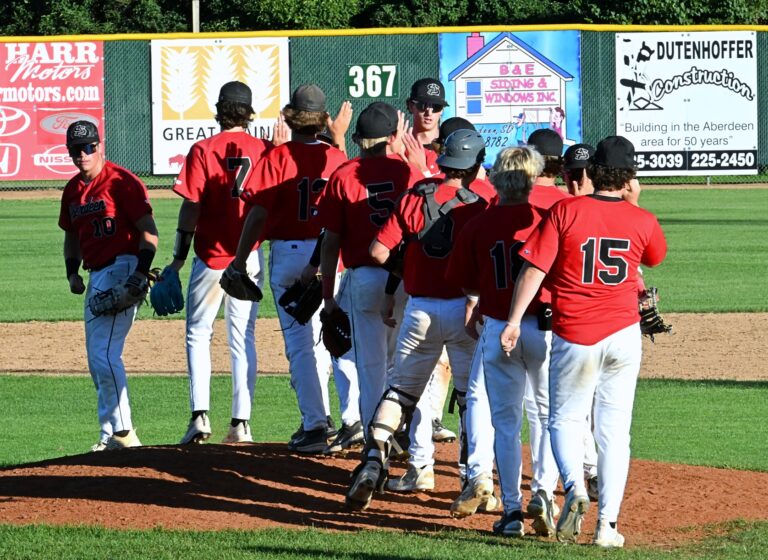 Members of the Aberdeen Smittys American Legion baseball team meet on the mound following a recent win against Pierre. American Legion baseball is celebrating its 100-year anniversary this month after it was established in Milbank in July 1925. Aberdeen Insider photo by Robb Garofalo.