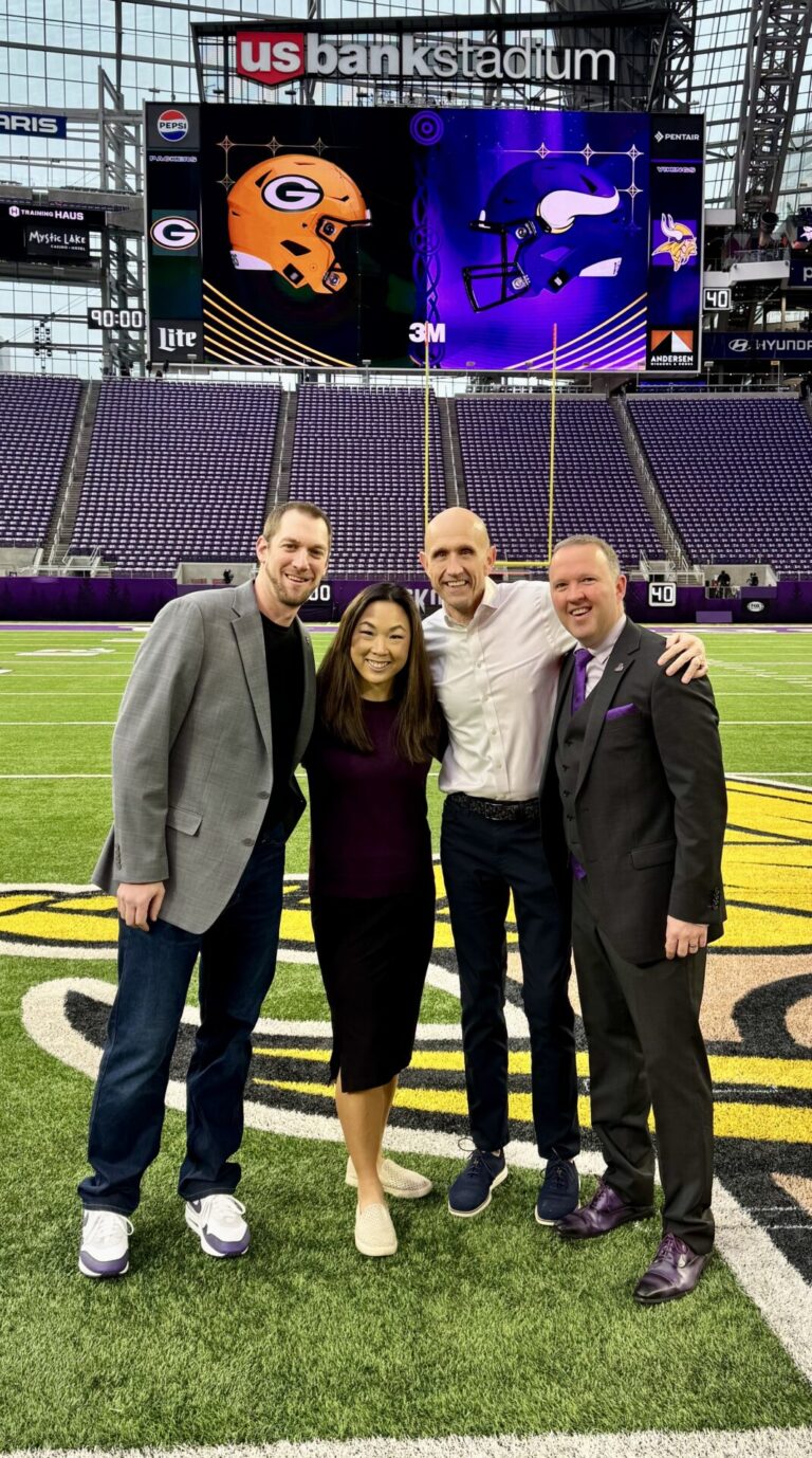 Aberdeen native Skip Krueger, third from left, is the director of broadcasting and original content for the Minnesota Vikings. With him on the field at U.S. Bank Stadium are coworkers Allan Wertheimer, senior director of production operations and game presentation, left; Heather Larsen, senior director of digital marketing and content strategy; and Bryan Harper, vice president of content and production. Courtesy photo.