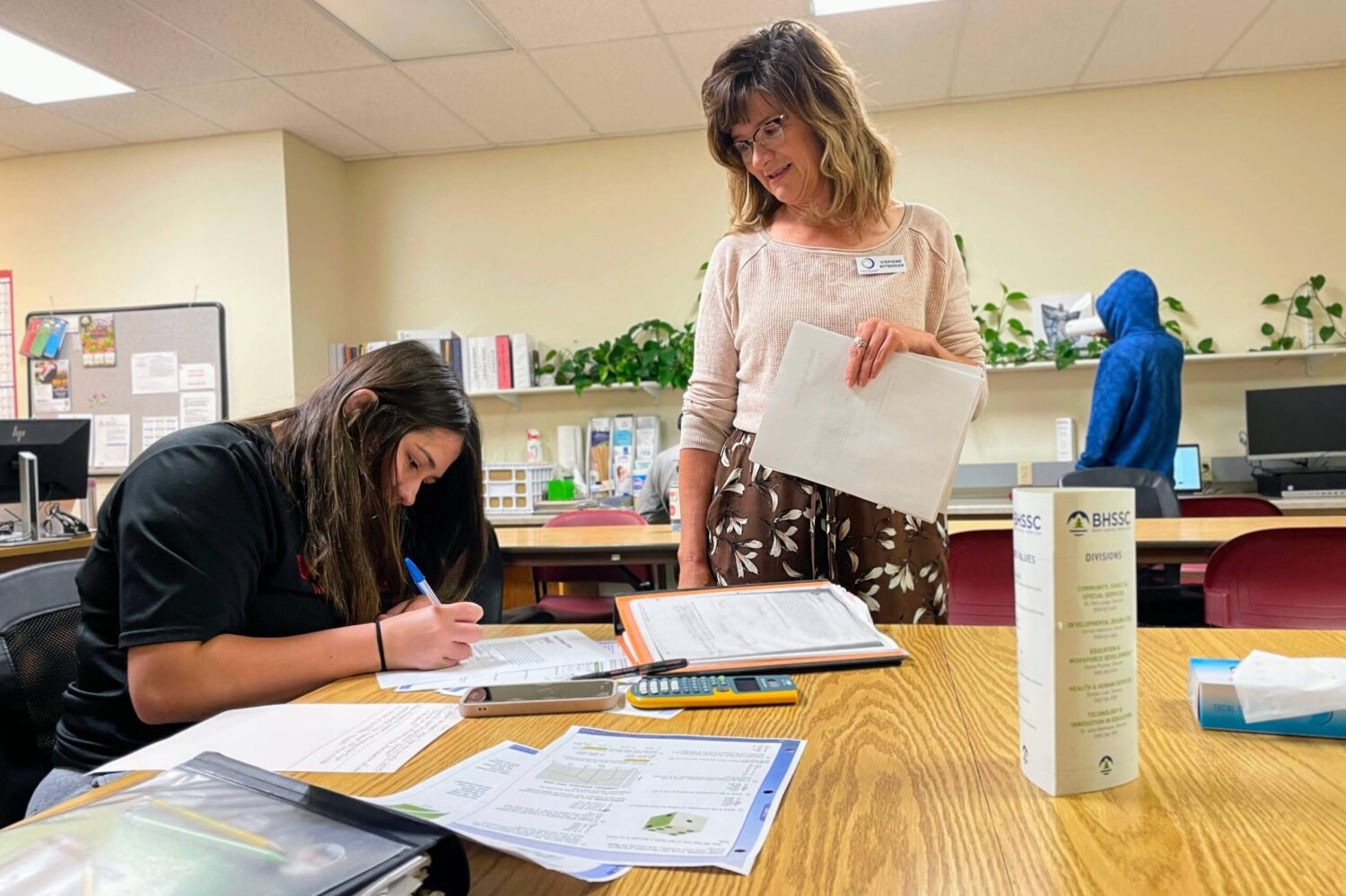 Stephenie Rittberger, adult education program manager, helps Erica Anderson with math on July 17 at the Career Learning Center of the Black Hills in Rapid City. South Dakota Searchlight photo by Seth Tupper.