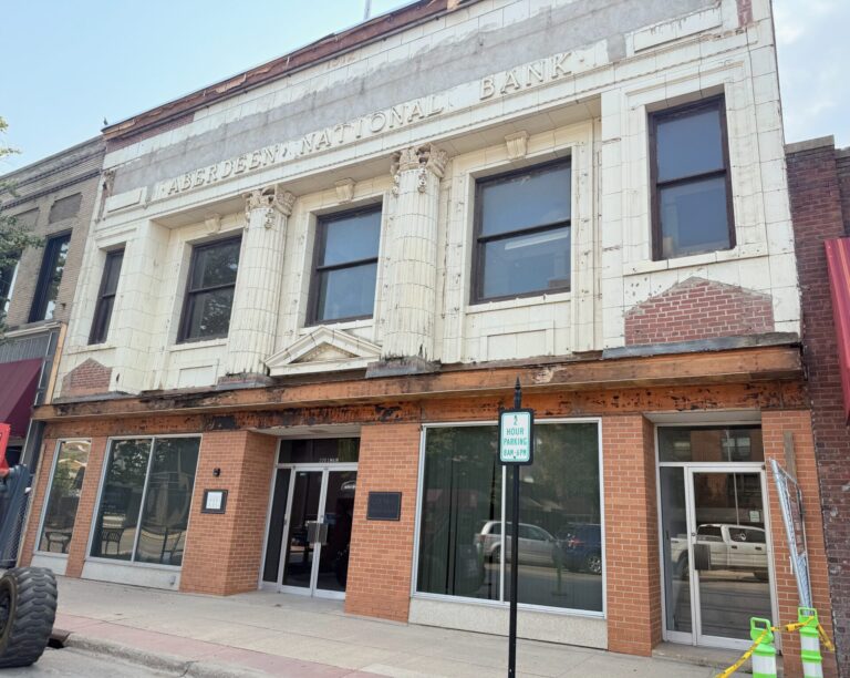 Construction workers removed a front facade covering the original architecture of the former Aberdeen National Bank in late July. Artist Benjamin Victor is converting the downtown building into a museum, studio and gallery. Aberdeen Insider photo by Elisa Sand.