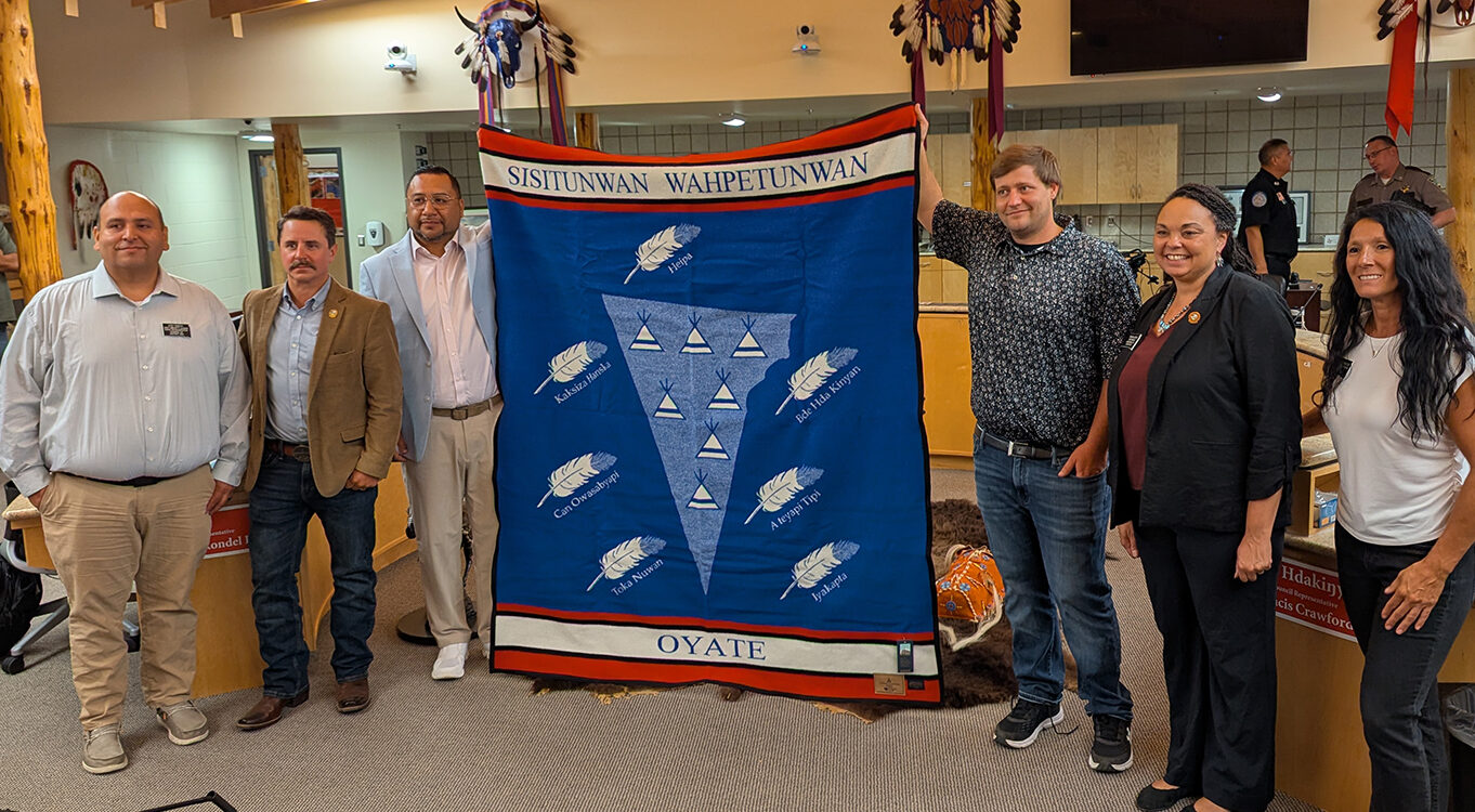 Sisseton-Wahpeton leader calls lawmaker’s now-deleted social media post ‘inflammatory’ 3 From left, Rep. Eric Emery, D-Rosebud; Rep. Will Mortenson, R-Fort Pierre; Sisseton-Wahpeton Oyate Tribal Chairman J. Garret Renville; Sen. Mike Rohl, R-Aberdeen; Sen. Tamara Grove, R-Lower Brule; and Rep. Heather Baxter, R-Rapid City; pose for a photo with a blanket given by the tribe to lawmakers on the State-Tribal Relations Committee. South Dakota Searchlight photo by John Hult.