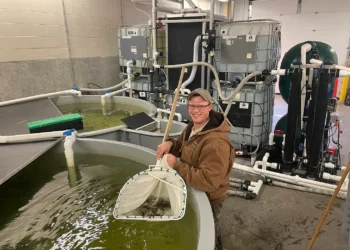 Cody Treft at Cleghorn Springs State Fish Hatchery with the first recirculating aquaculture he and Brian Fletcher designed and built in their shop. Courtesy photo.