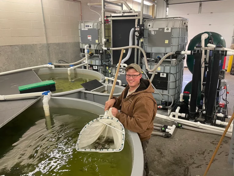 Cody Treft at Cleghorn Springs State Fish Hatchery with the first recirculating aquaculture he and Brian Fletcher designed and built in their shop. Courtesy photo.