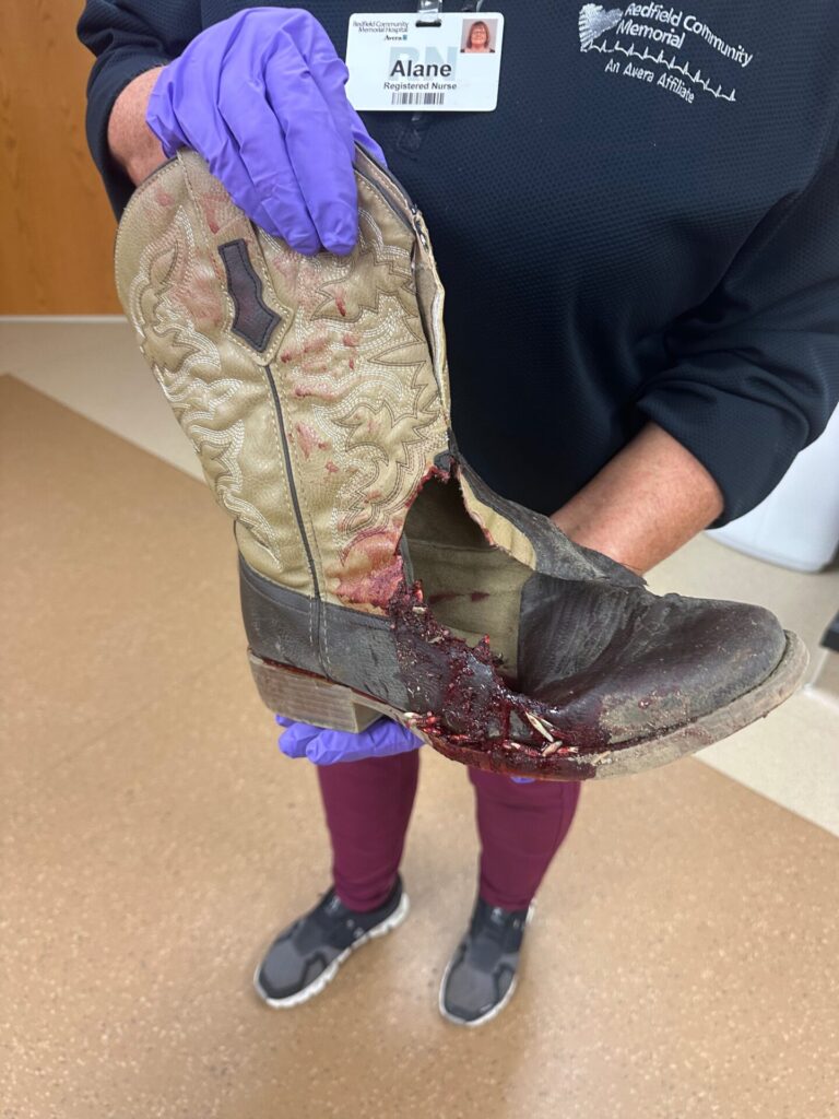 Jackson Metz's boot damaged by an auger in a farming accident. He's the head wrestling coach for Warner/Northwestern. Courtesy photo.