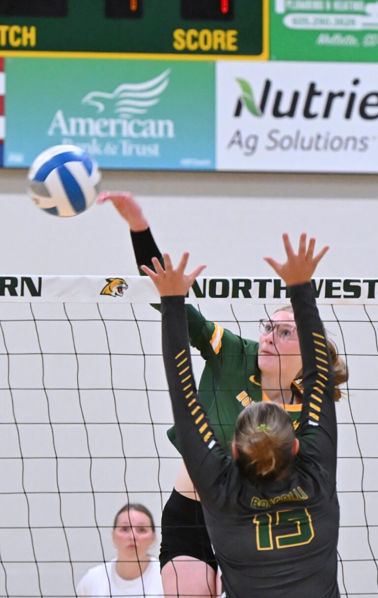 Northwestern's Ashley Haven hits around the block attempt of Roncalli's Reese Henrich for one of her 21 kills Tuesday, Aug. 26 in Mellette. Aberdeen Insider photo by Allie Hoekman.