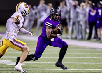 University of Sioux Falls running back Bubba Tann III tries to evade Northern State University defensive back Kyle Thomas as the Cougars picked up a 42-28 victory on Saturday, Sept. 6 in Sioux Falls. Photo courtesy of Jurgens Photography.