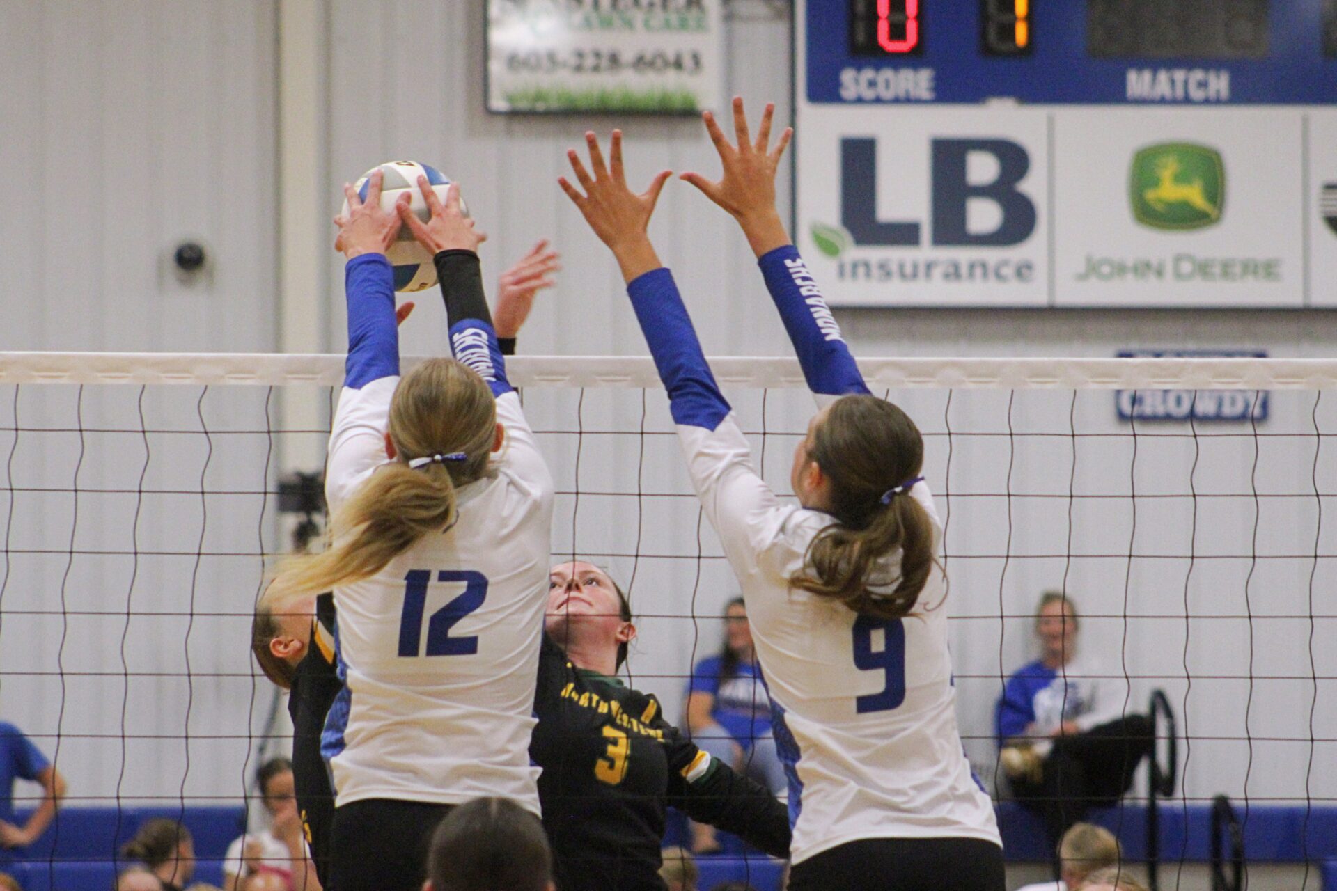 Warner's MaKenna Leidholt (12) gets the block on Northwestern's Breelyn Satter during their match Thursday, Sept. 11 in Warner. Assisting on the block attempt is Molly VanHatten. Northwestern won the match in four sets. Aberdeen Insider photo by Allie Hoekman.