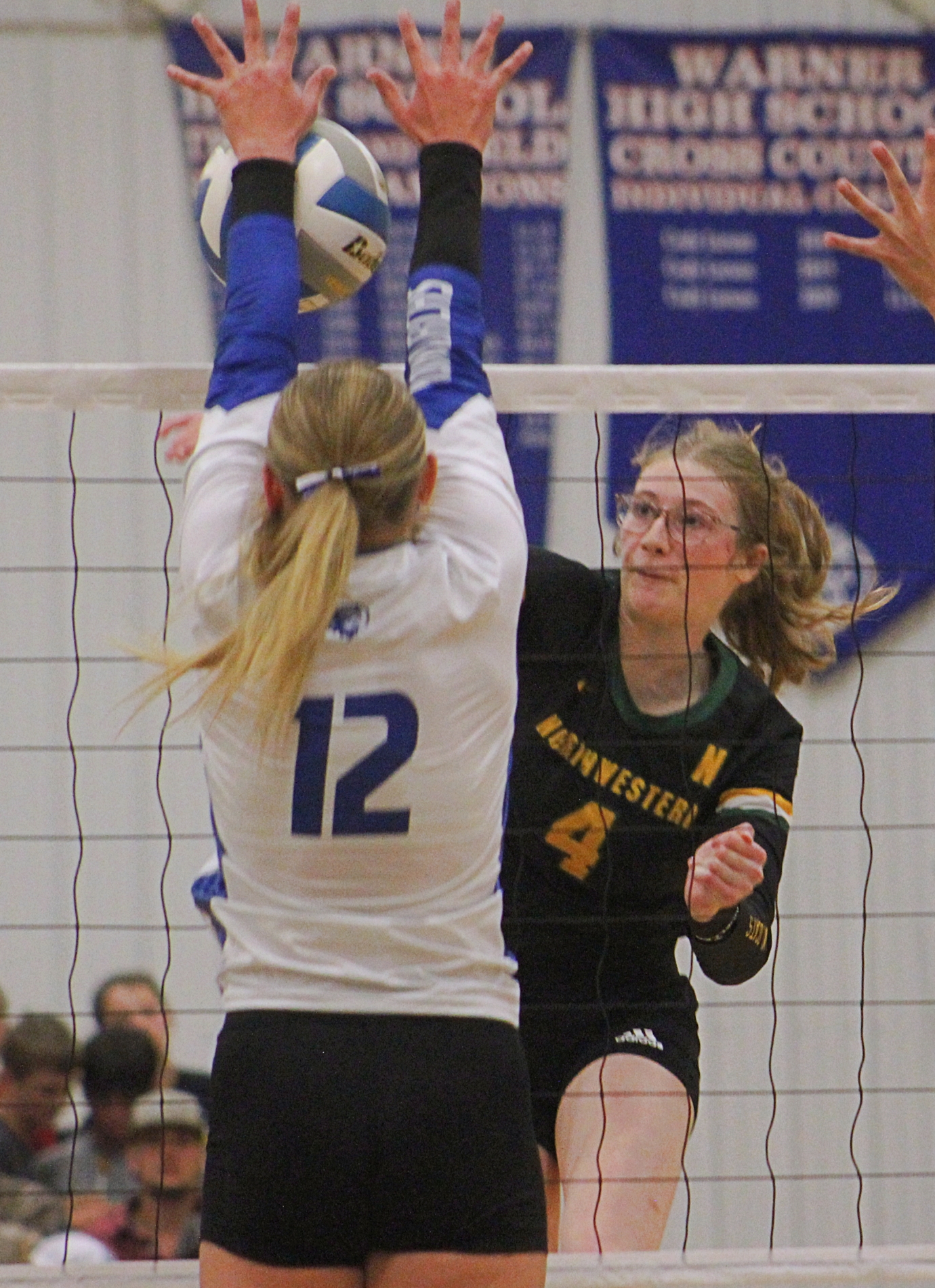 Northwestern's Ashley Haven tries to hit through the block attempt of Warner's Makenna Leidholt during their match Thursday, Sept. 11 in Warner. Haven had 20 kills to help her team get the win. Aberdeen Insider photo by Allie Hoekman.