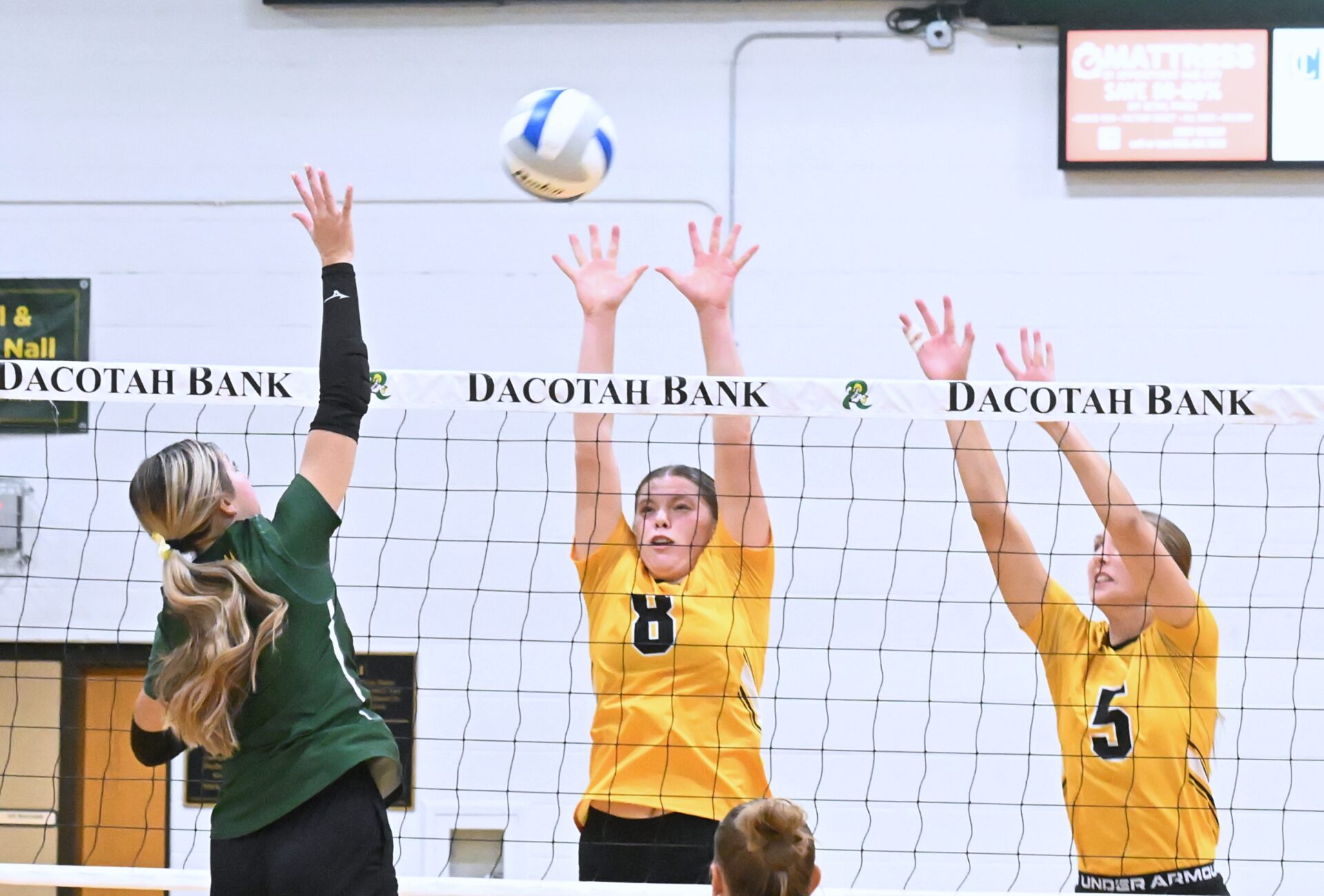 Aberdeen Roncalli's Jillian Ellwein attempts to hit over the block of Groton's Chesney Weber (8) and Taryn Traphagen Thursday, Sept. 11 at the Roncalli Gym. Ellwein had nine kills, but Groton swept the Cavaliers in three sets. Aberdeen Insider photo by Robb Garofalo.