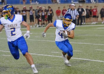 Aberdeen Central's Preston Welke carries the ball during the game against Brookings Friday, Sept. 12 iat Dana Dykhouse J. Stadium in Brookings. Leading the way is teammate Joey Dallman. The Golden Eagles lost 17-14. Aberdeen Insider photo by Kevin Foss.