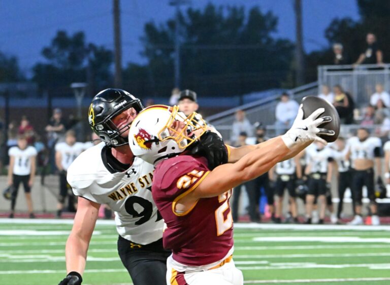 Northern State's Hank Kraft reaches out and makes a catch in the end zone during the Wolves' 26-7 victory over Wayne State on Saturday, Sept. 13 at Dacotah Bank Stadium. Defending for Wayne State is James Frank. Aberdeen Insider photo by Robb Garofalo.