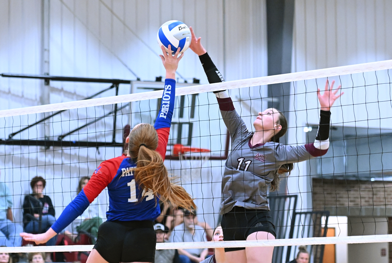 Aberdeen Christian's Ari Johnson, right, and Hitchcock-Tulare's Gracyn Bixler battle to win a point during the third set of their match Tuesday, Sept. 16 at the Aberdeen Christian Gym. Johnson put the ball down for the point, but Hitchcock-Tulare won the match in four sets. Aberdeen Insider photo by Robb Garofalo.