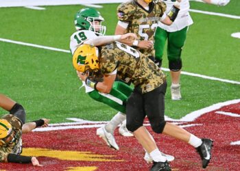Aberdeen Roncalli's Mason Berndt levels Miller/Highmore-Harrold quarterback Chase Hurd after a pass attempt during the third quarter Thursday, Sept. 18 at Dacotah Bank Stadium. Hurd's pass was incomplete. The Avaliers won 18-6. Aberdeen Insider photo by Robb Garofalo.