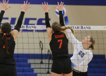 Aberdeen Central's Lauryn Burckhard tries to hit through the block attempt of Sioux Falls Sioux Falls Washington's Dana Harpe (7) and Jersey Peterson during their match Thursday, Sept. 18 at Golden Eagles Arena. Burckhard was named to the Class AA high school volleyball all-state second team for a second consecutive year. Aberdeen Insider photo by Robb Garofalo.