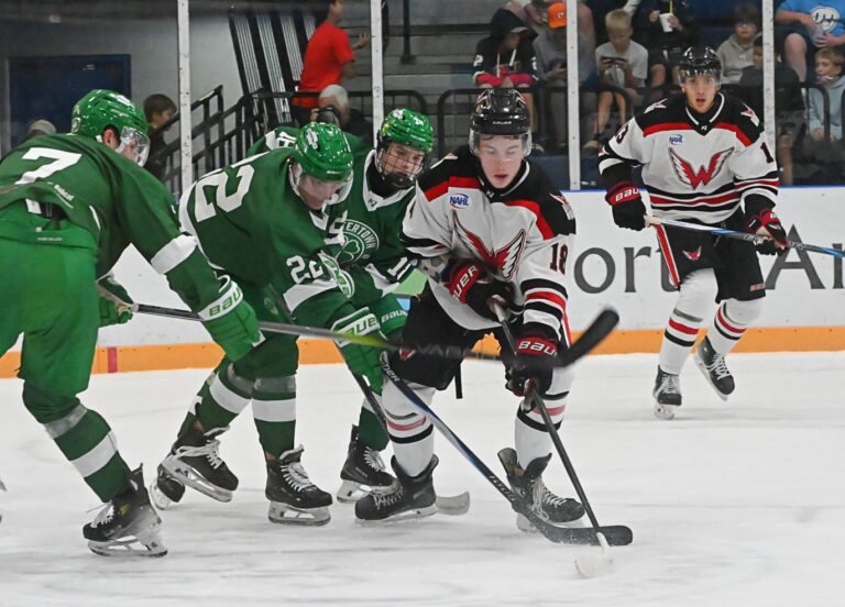 Aberdeen Wings forward Jack McDonough beats Watertown's Justin Bartley, left, Owen Chartier and Justin Obrochta to the puck during the first period of their game Friday, Sept. 19 at the Odde Ice Center. McDonough gathered the puck and scored to tie the game at one. Trailing the play is Wings forward Matthew Martin. The Wings won 6-1. Aberdeen Insider photo by Robb Garofalo.